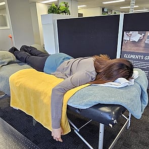 Lady lying on massage table from Mobile Healing Hands