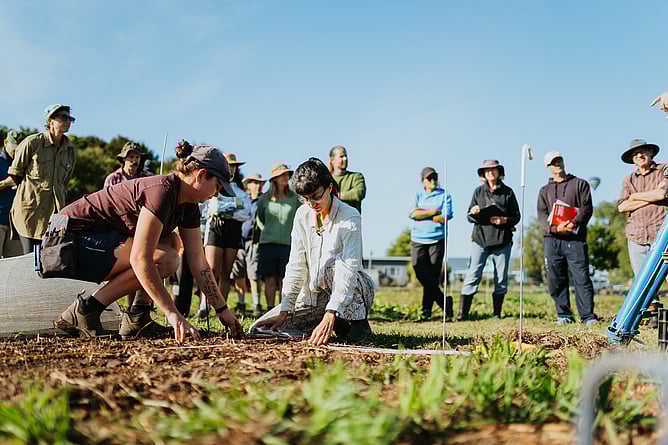Image of members of the Earthworkers teaching growers biology-first regenerative growing. New Zealand.