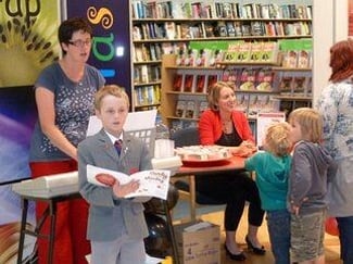Bob and his mum, Julie sing, while Emma signs.