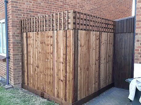 Closeboard fencing with trellis. Built on timber posts, treated in brown tanatone.