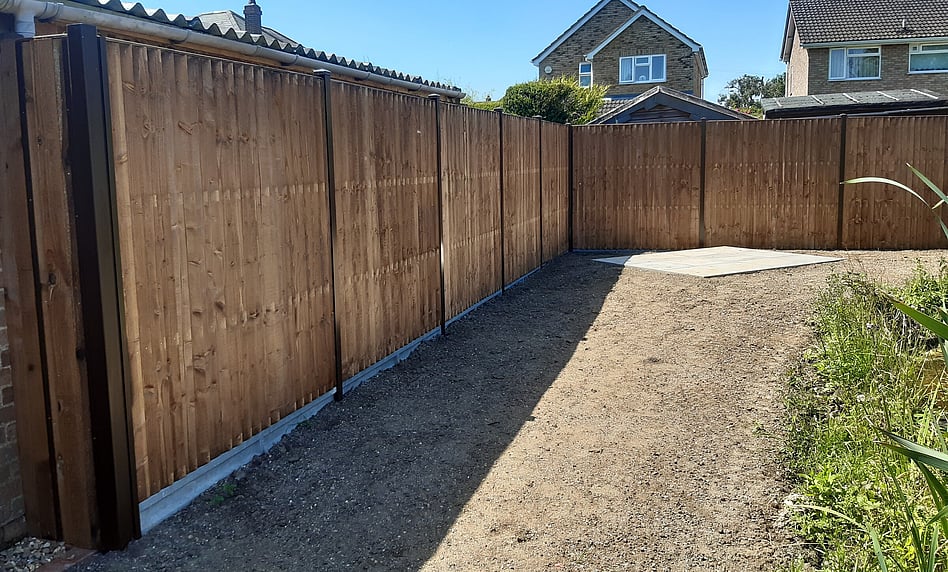 Image shows 6' closeboard panels sitting on 6" concrete gravelboards fitted to classic type posts made by Durapost. Part of a larger landscape job the image alos shows preparation for turfing and a paved area for a swing seat.