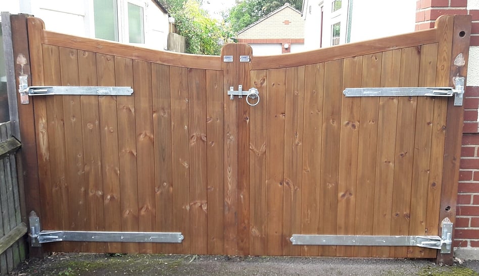 bespoke double leaf gates with a curved (concave) top. Hung with adjustable hinges.