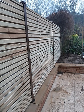 Durapost Brown Posts with slatted panels. - No other fence post would allow this type of fitting. The Durapost system is very flexible for modern garden designs.