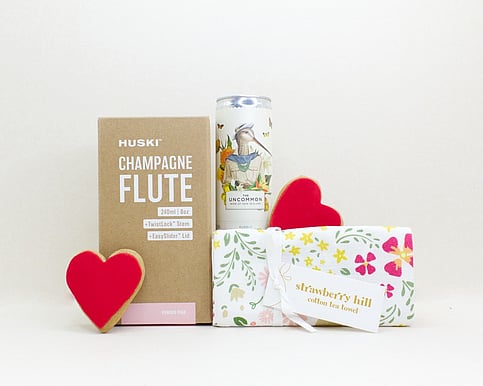 nz designed teatowel, champagne flute and a wine can