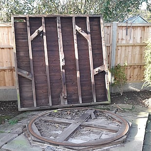 Image shows the base of the summer house standing up on its side. This exposes the steel circular base and the castors that allowed the house to rotate in a circle