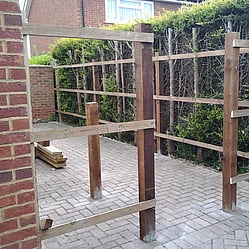 Closeboard framework installed with timber posts and cant rails