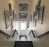 narrow staircase entrance with black painted floor