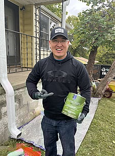 Christmas in October volunteer posing with paint