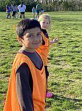 Two youth soccer players looking at camera during a break in the game