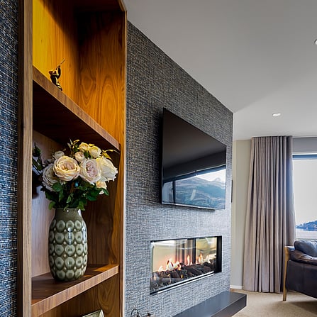 A designer inbuilt gas fireplace in the lounge with the tv mounted above.