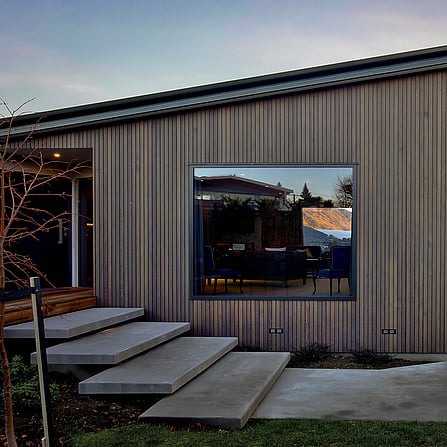 Clever stacked concrete steps leading up beside the house into the entrance way.