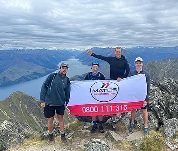 The Fixation Team out on the mountain trail with a MATES in Construction banner.