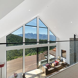 Looking down the side of the home exterior with board and batten cladding.