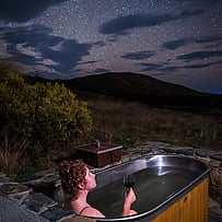 Stargazing from bed beneath the glass roof at SkyScape