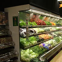 Fresh fruit and vegetables misted on supermarket shelf 2