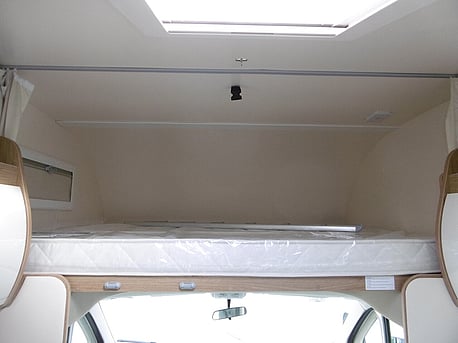 king size overhead bed, with light, window and kids safety rail.