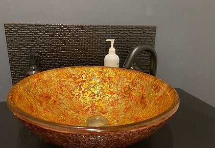 the ET2-OL24.1 Gooseneck tap finished in gunmetal and installed with a raised glass basin