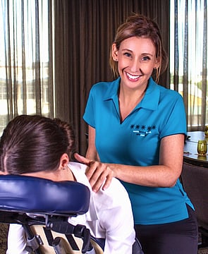 Seated Massage therapist from Mobile Healing Hands providing massage on seated massage chair