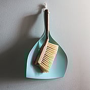 Broom for cleaning hanging up on wall