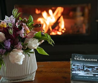 cosy fireplace and fresh flowers on the coffee table