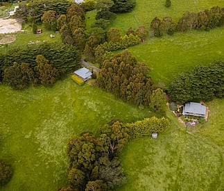 aerial view showing cottages nestled into the hillside with distance and privacy