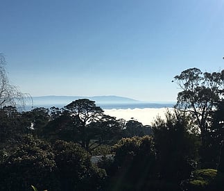 distant mountains and blue sky  with foggy vally below