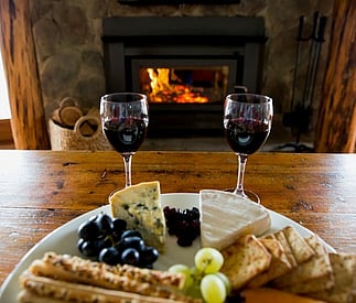 cosy fire with red wine and cheese plate