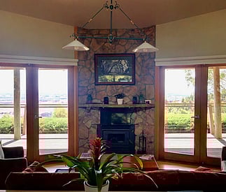 lounge room with fireplace and french doors onto deck and views beyond