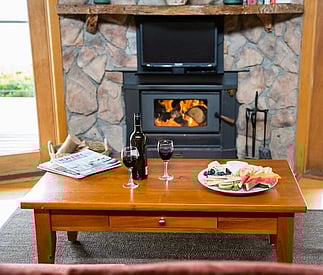 fire with coffee table set for wine and cheese