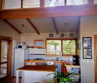 kitchen showing island bench and high windows