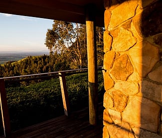 deck with timber posts and stonework on chimney