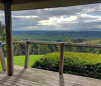 deck and view below to the valley and dramatic cloudy skies