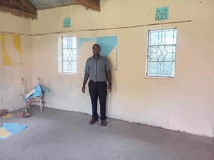 Geoffrey standing in one of the classrooms as the interior painting begins.
