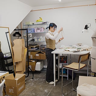 Patter cutter, Mina Zhao working at her studio - the 'Classic' studio. Size ranges from 140 - 180 sqft.