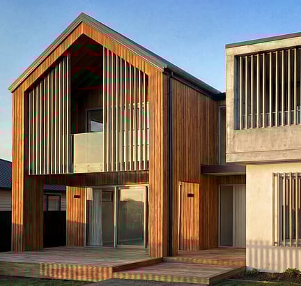 Modern architectural home with vertical timber cladding and aluminium screening elements
