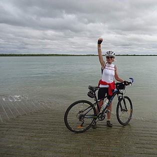 The rider celebrating by the Gulf at Karumba