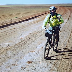 The cyclist on gravel road
