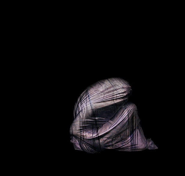 Pink canvas sneaker style pair of boots, with pink satin flower decoration. The boot in the forground has a sole that higher than the other boot. Especially adapted for Indie right leg which is shorter than her left. 