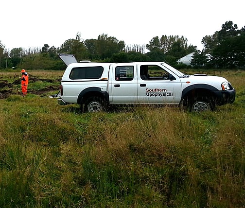 Southern Geophysical white ute parked in field