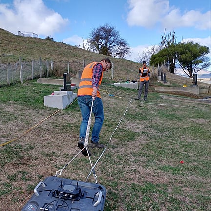 two scientist using ground surveying equipment