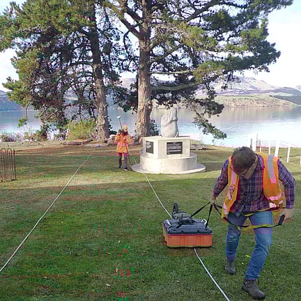 two scientist using ground surveying equipment