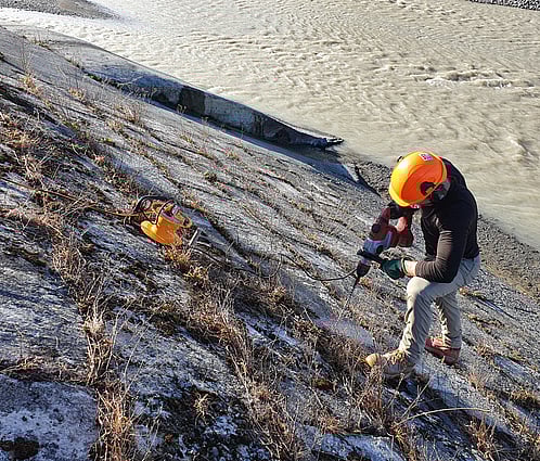 A metal ruler measuring a hole depth
