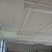 Asbestos insulation board to walls and ceilings of a portakabin