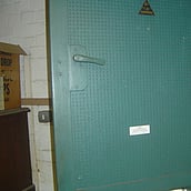 Asbestos insulation board within a durasteel door
