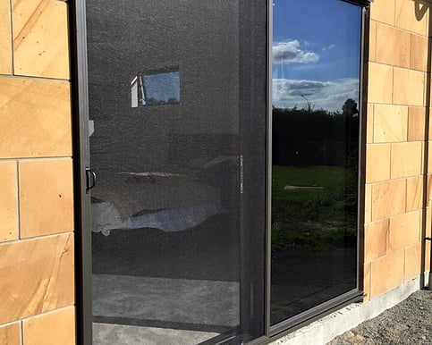 Image of a doorway fitted with a security screen.