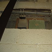 Asbestos sprayed coating around an electrical fuse box