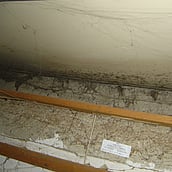 Asbestos sprayed coating to a structural beam