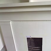 Asbestos cement panel over a fireplace