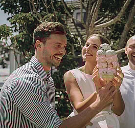 A bride and groom enjoying a Kūaotunu killer ice cream from the Kūaotunu Store