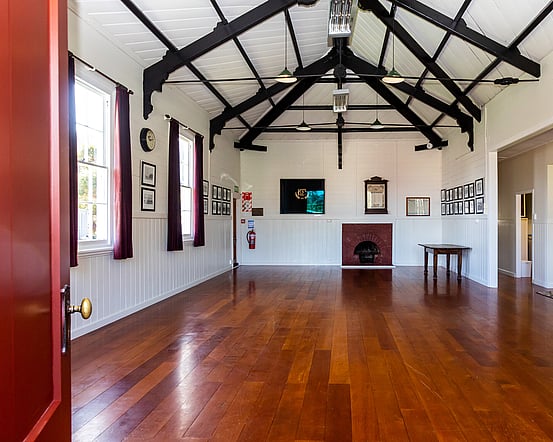 The inside of the main part of the Kūaotunu Hall, looking towards the main door